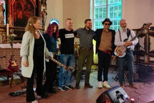 Rock Around the Church band standing together on stage